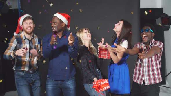 Young Multiethnic Friends Dancing at Christmas Party in Studio