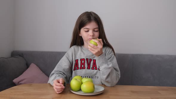 Small Young Teen Girl Eating an Apple