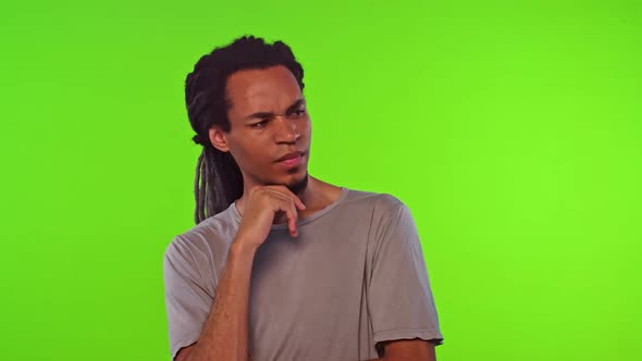 Young African American Man Student Looks Into Distance in Thought Crosses Arms alt