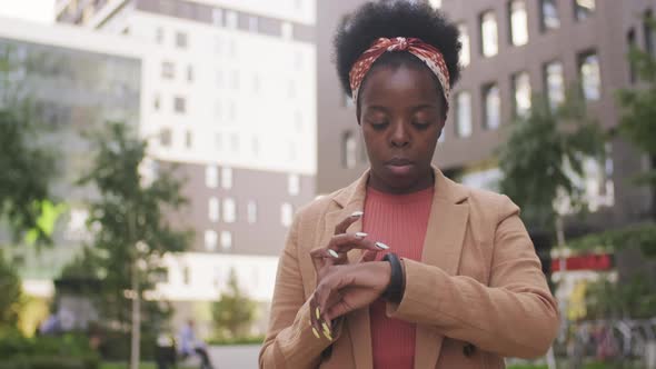  Black Businesswoman Using Smartwatch Outside alt