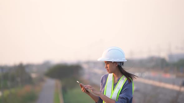 Female civil Engineering working with tablet on bridge highway