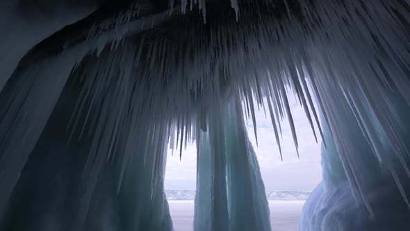 Big Stalactites Sharp Icicles Frozen Cave and Blue Ice Iceberg of Lake Baikal