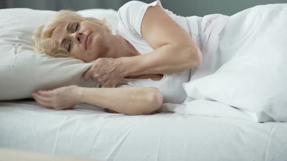 Happy Middle-Aged Female Sleeping in Bed on Orthopedic Mattress, Health alt