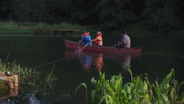 Kids at summer camp canoeing and fishing