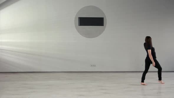 Pretty Girl Rehearsing Modern Dance in Studio alt