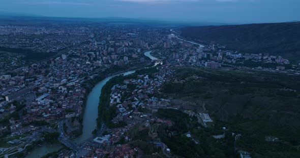 Aerial view of Tbilisi old town buildings and Narikala fortress landmark on hill alt