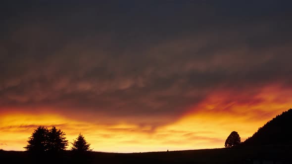 The Sun Illuminates the Clouds in Fiery Colors After the Storm