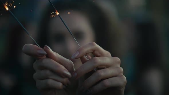Caucasian young woman  dancing on music festival with sparklers. Shot with RED helium camera in 8K. alt