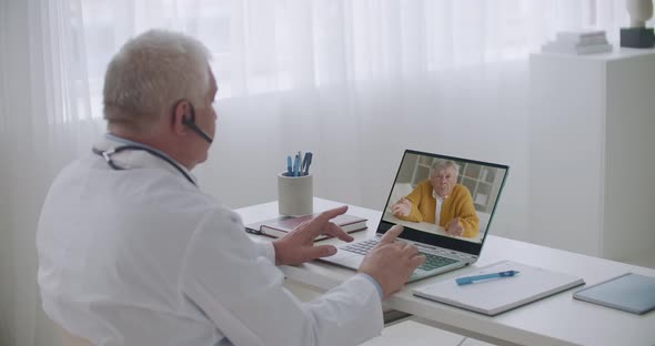 Online Appointment of Gastroenterologist, Elderly Male Patient Is Consulting with Doctor By Internet alt