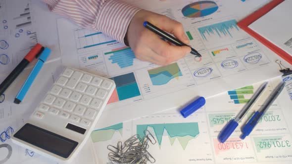 Hand of Accountant is Counting Financial Report on Calculator Closeup alt