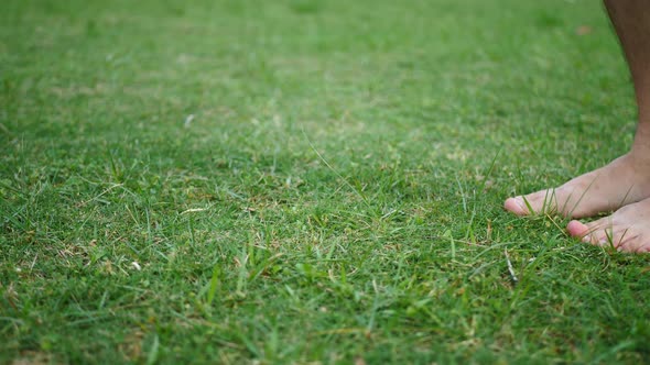 Adult Male Trots On Newly Mown Green Grass With Bare Feet