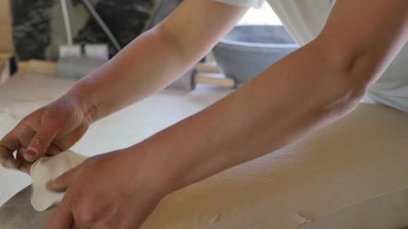the Female Hands of the Baker Lay Out a Thin Dough Rolled Out with a Rolling Pin on a Shrinkable alt