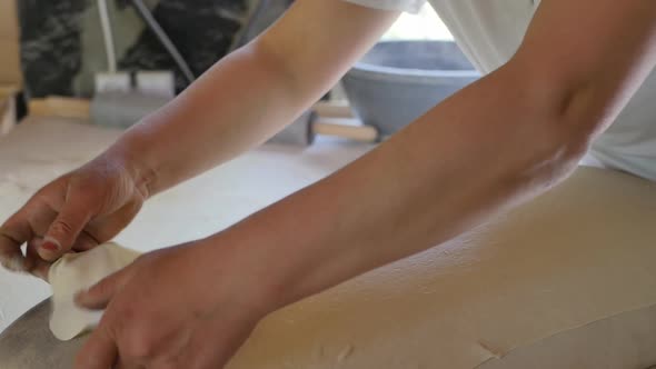 the Female Hands of the Baker Lay Out a Thin Dough Rolled Out with a Rolling Pin on a Shrinkable