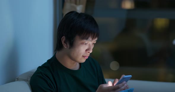 Man Use of Mobile Phone at Home in The Evening alt