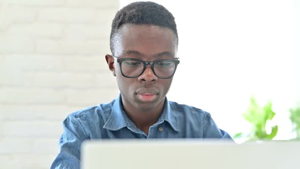 Portrait of Excited Young African Man Celebrating Success on Laptop alt