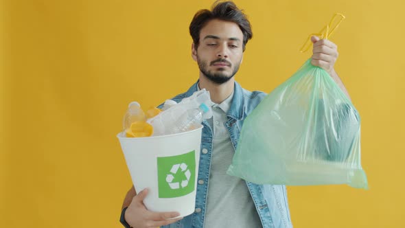 Young Middle Eastern Man Choosing Plastic Recycling Over Throwing Away Trash alt