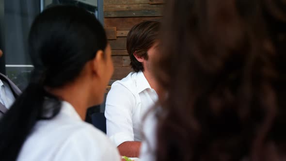 Group of business executives having breakfast alt