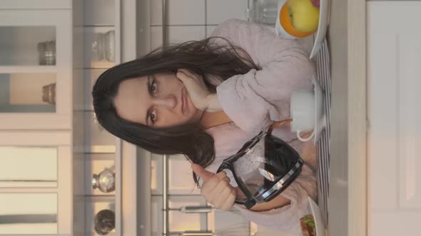 Exhausted Woman Pouring Coffee Early in Morning alt