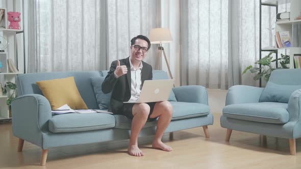 Full View Of Asian Businessman In Jacket And Shorts Smiling And Showing Thumbs Up Gesture To Camera alt