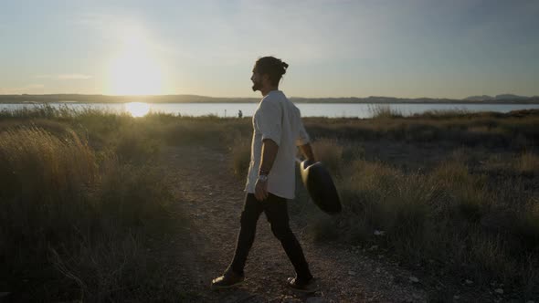 The Man with Guitar Spinning in a Circle Against the Beautiful Sunset alt