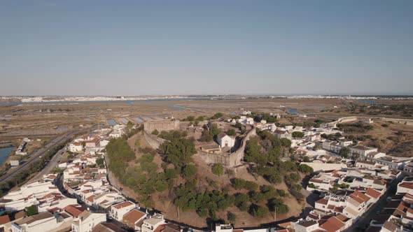Castro Marim medieval castle. Algarve, Portugal . Small houses and salt pans. Aerial view alt