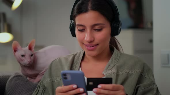 A Young Girl Makes a Payment on the Internet Via a Mobile Phone