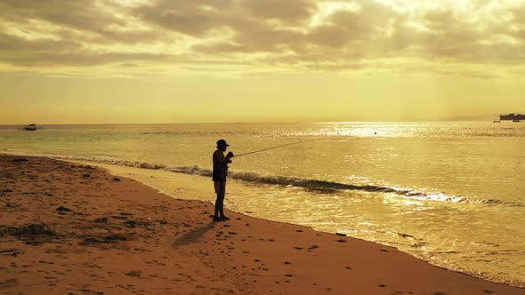 Fishing Happy guy on vacation hanging out on beach on summer white sandy and blue background 4K alt