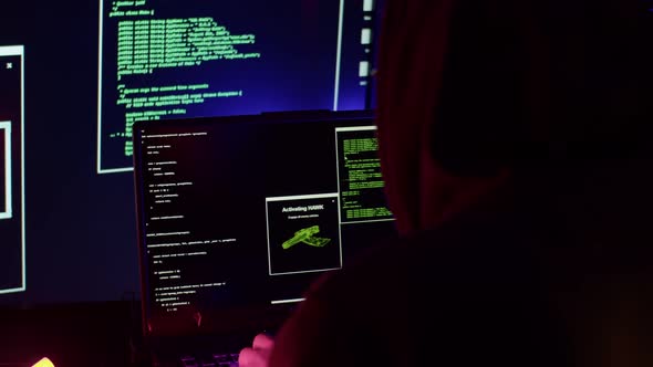 A Programmer in a Black Hoodie Hacks a Website
