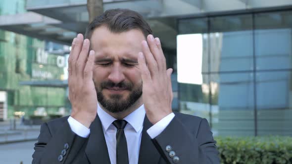 Beard Businessman Upset By Loss While Working in Office alt