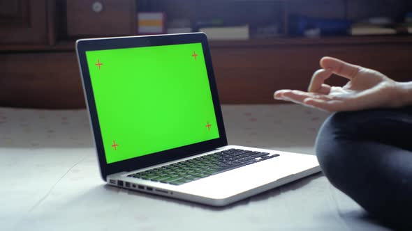 Young woman using with chroma key green screen laptop on bedroom