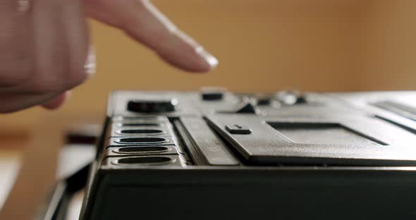 Male Hands Extract an Audio Cassette Into a Retro Tape Recorder alt