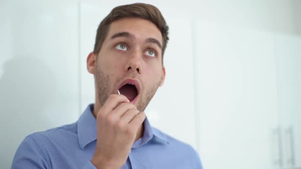 Closeup Face of Handsome Young Man Taking Swab Sample of Mouth with Cotton Stick for DNA Tests alt