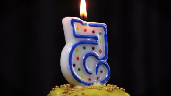 Cupcake with a Burning Candle with the Number 5.