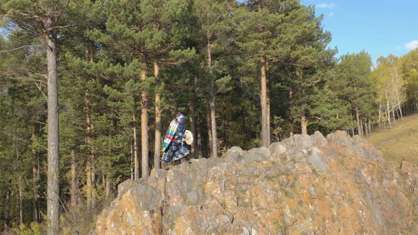 An Old Siberian Shaman Addresses the Spirits of the Forest with a Tambourine alt