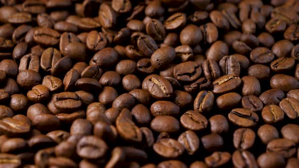 Roasted coffee beans. Slow motion of arabica coffee seeds falling. alt