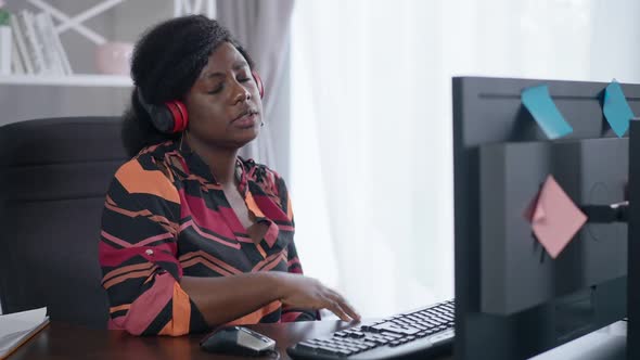 Stressed African American Woman in Headphones Gesturing No Conferencing Online in Home Office alt