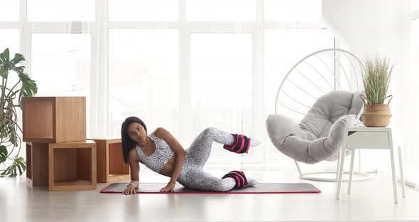 Black woman in sportswear training strength practicing fitness females aerobics sport fit at home. alt