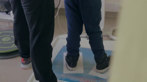 Child doing treatment exercise playing game alt