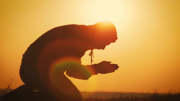 Silhouette Young Man Praying Outside at Beautiful Sunset. Male Asks for ...