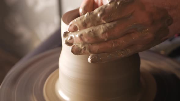 An Elderly Woman Senior Professional Potter in Workshop Makes Jug Out of Clay
