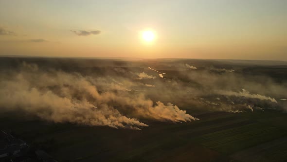 Aerial Shot In Ukraine At Sunset, Burning Grass. Emissions Into The Atmosphere alt