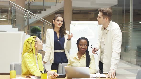 Cheerful Young People in Stylish Casual Clothes Looking at Each Other. alt