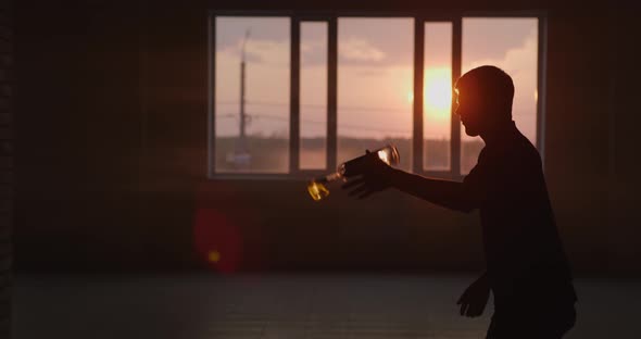 Man Doing Trick Spraying Vodka Flame From Bottle alt