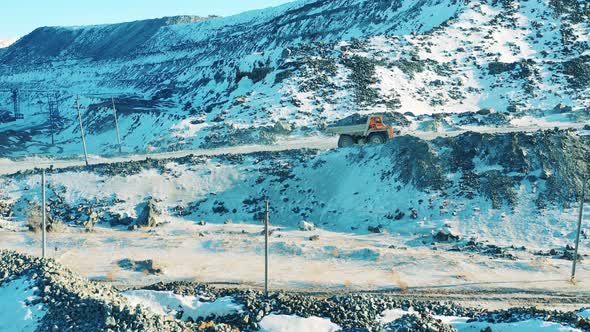 Loaded Truck is Riding Along the Road in the Open Pit alt
