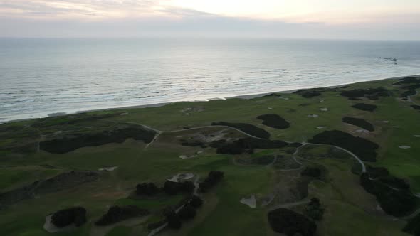 Beautiful PNW Sunset on Oregon Coast over Bandon Dunes Golf Course, Aerial alt