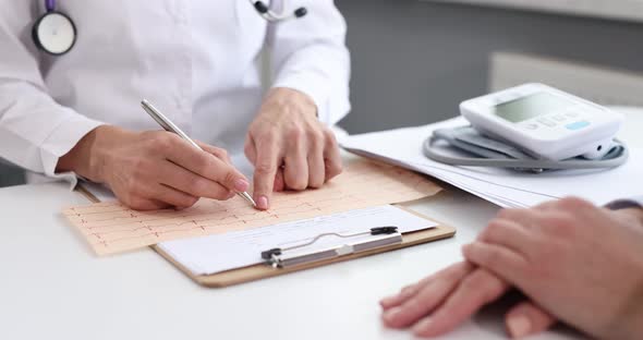 Doctor Cardiologist Examines Cardiogram of Heart of Sick Patient  Movie alt