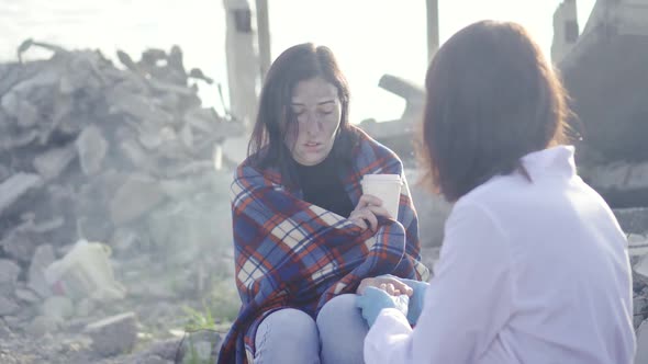 Portrait of Dirty Face Woman Survivor After Fire or Natural Disaster and Doctor with White Coat alt