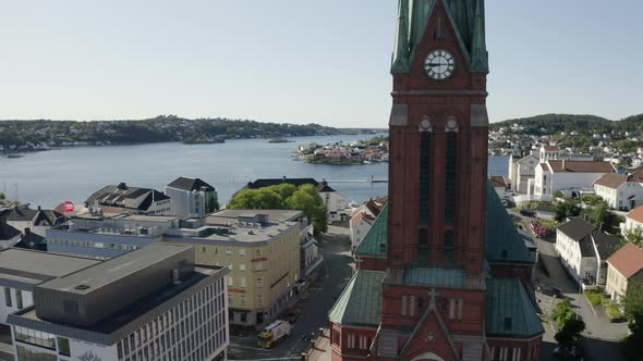 Clock Tower Of The Trinity Church With The Arendal City Overlooking The Norwegian Coast On A Sunny D alt