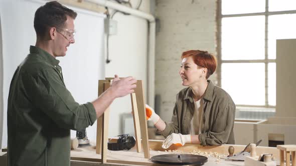 Cheerful Joiners In Casual Shirt Have Talk While Working Making New Chair