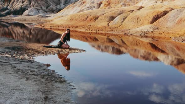 Beautiful woman posing on other-worldly hilly landscape